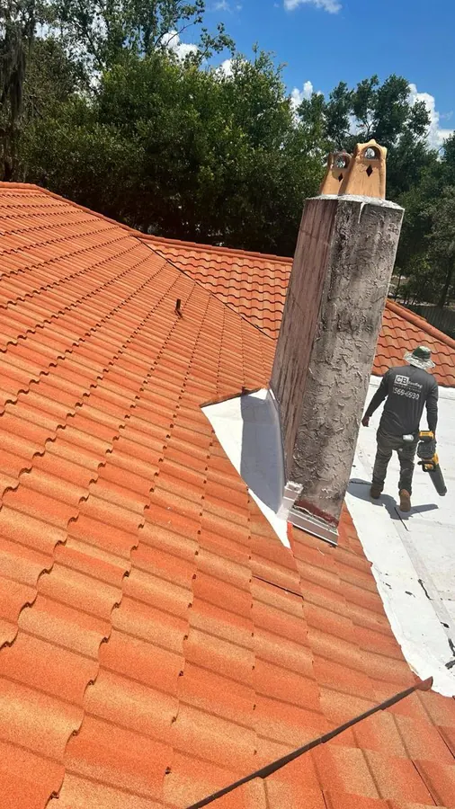 Roofer walking on a terracotta tile roof