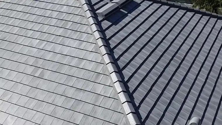 Close-up view of a residential tile roof showing the installed roofing tiles and finished roof surface.