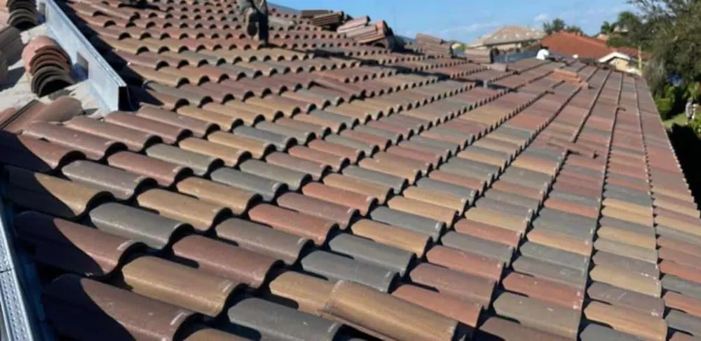 Close-up view of a completed residential tile roof showing the pattern and condition of the installed roofing tiles.