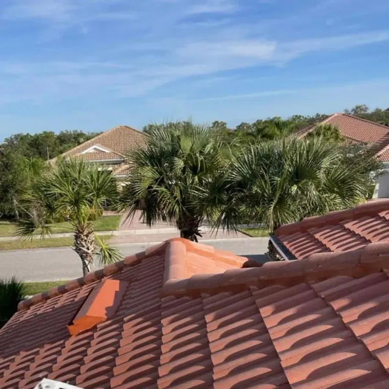 Close-up view of installed roof tiles on a residential home, showing the finished tile roofing surface.